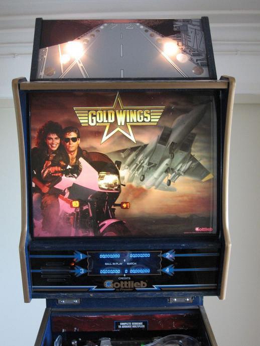 Gold Wings is a pinball machine themed around aviation, featuring a vibrant playfield and engaging gameplay elements typical of mid-80s machines.