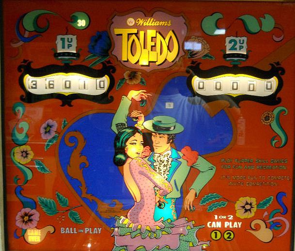 Toledo is a classic electromechanical pinball machine designed by Williams, released in 1975. It features a vibrant backglass and playfield artwork, typical of the era.
