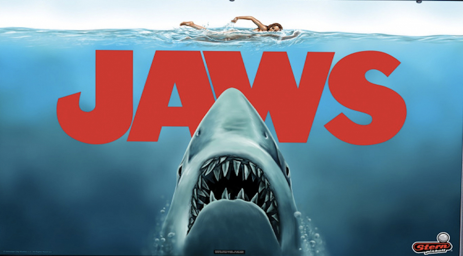 JAWS (Pro) is a pinball machine released by Stern in 2024, based on the iconic 1975 thriller film 'JAWS'. The game immerses players in the suspense and excitement of hunting the infamous great white shark.