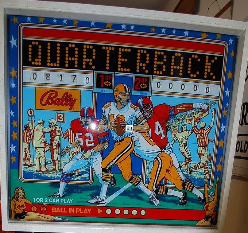 Quarterback is a 1976 electro-mechanical pinball machine designed and produced by Bally Manufacturing. The game builds on an American football theme, featuring vibrant backglass artwork and playfield design reflecting the sport.