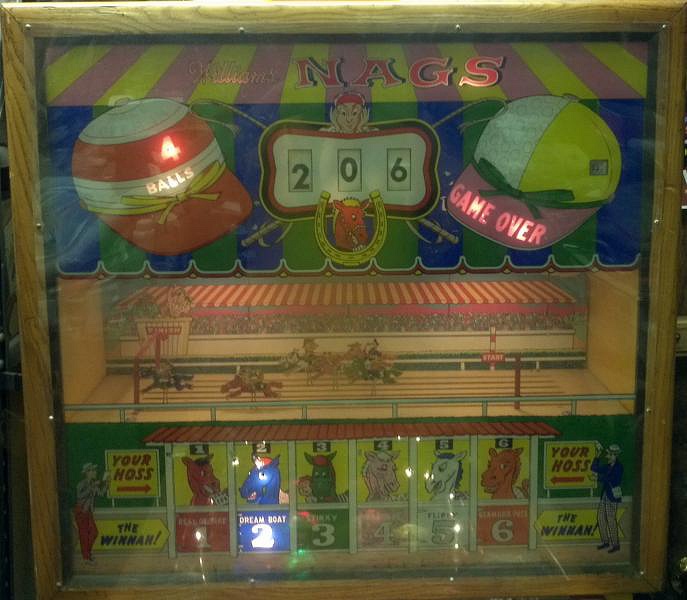 Nags is a 1960 electro-mechanical pinball machine produced by Williams. It's a horse racing-themed game where players aim to complete sequences to move horses across the track.